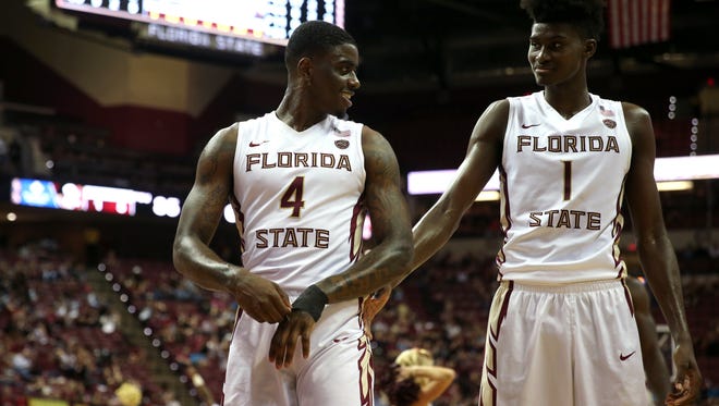 FSU’s Dwayne Bacon, left, shares a smile with Jonathan Isaac during the Seminoles 95-71 win against NC State at the Tucker Civic Center on Wednesday, Feb. 8, 2017. 