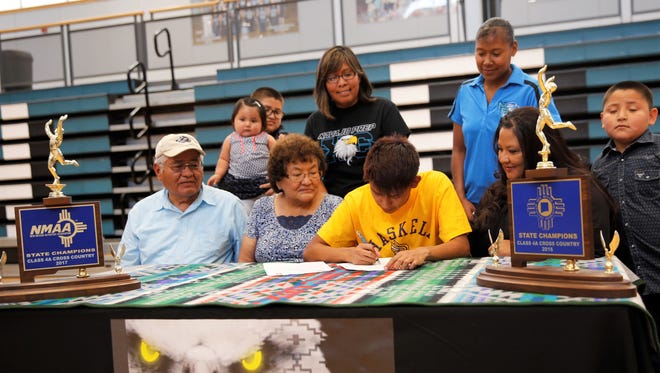Navajo Prep's Cameron Becenti signs his National Letter of Intent on Thursday to continue his cross-country career at Haskell College.