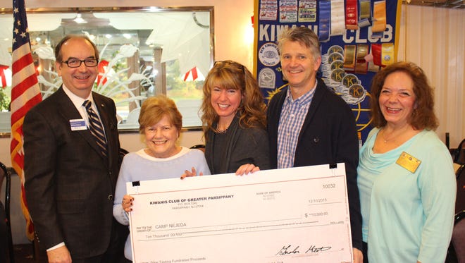 Wine Tasting Committee Chairman Michale Mulhaul, Foundation President Mimi Letts, presents a check for $10,000 to Camp Nejeda Development Director, Jennifer Passerini, Executive Director, Bill Vierbuchen, as Kiwanis President Connie Keller looks on