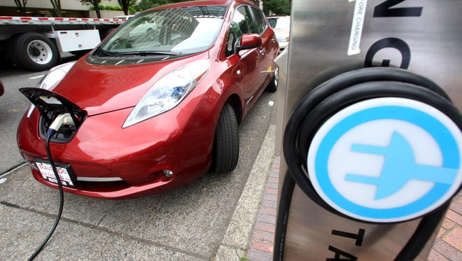 A Nissan Leaf charges at a electric vehicle charging station in Oregon.