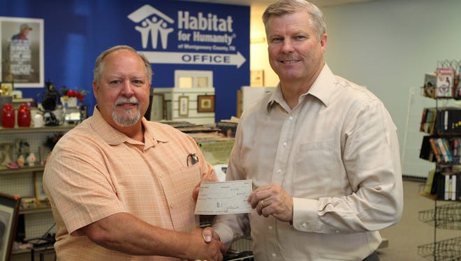 Sango United Methodist Church's Willie Lyle presented a $5,000 check Wednesday to Habitat for Humanity of Clarksville/Montgomery County's President Rick Catignani.