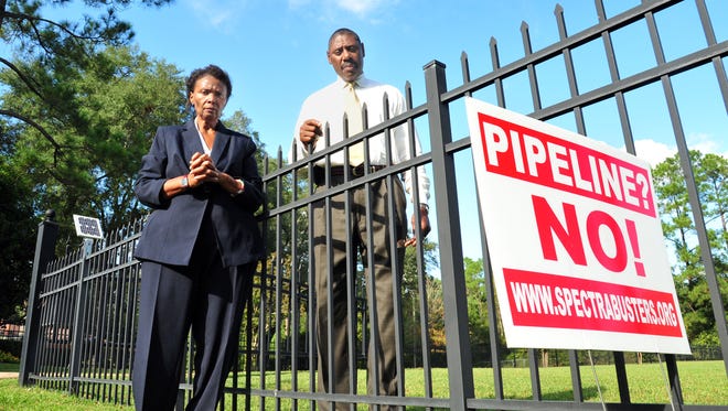 Former Dougherty County commissioner Gloria Gaines, left, and current commissioner John Hayes stand in Gaines' front yard near the proposed natural gas compressor site in Albany, Ga., Thursday, Oct. 9, 2014.
