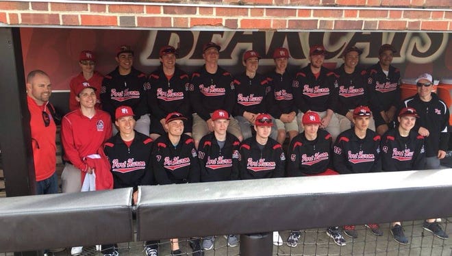 Port Huron's baseball team poses in University of Cincinnati's dugout during a tour of their athletic facilities.