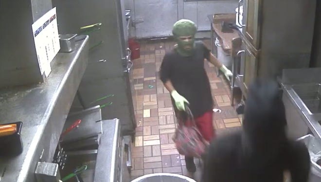 Police are looking to identify these two men who robbed a local fast food store at gunpoint in July.