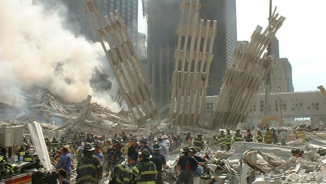 This photo taken by New York City firefighter Michael J. Leddy II, father of Dr. Michael J. Leddy III of Alexandria, shows firefighters sorting through the rubble at Ground Zero following the Sept. 11, 2001, terrorist attacks.