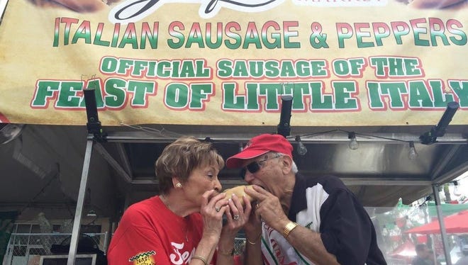 Two attendees from the 2015 Feast of Little Italy feast on great festival food. This year's 14th annual Feast in downtown Abacoa is scheduled from Nov. 4 through 6. It will showcase family fun, authentic Italian food, entertainment, festival rides and games.
