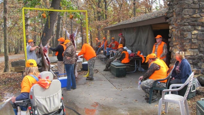 A group of hunters take time out to discuss the adventures of the day at the special hunt.