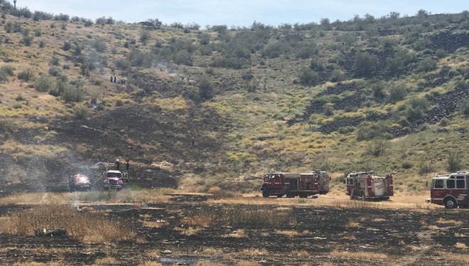 Fire crews were working to stop a slow burning brush fire near Interstate 17 and Carefree Highway Sunday afternoon.
