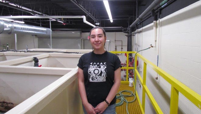 Lab Technician Celina Apodaca with the new wastewater treatment plant at Doña Ana Community College.
