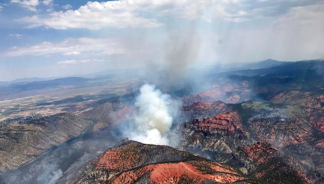 This Monday, June 26, 2017, photo provided by the Utah Governor's Office, shows fire activity near Parowan, during a tour by Utah Lt. Gov. Spencer Cox, in southern Utah. The nation's largest wildfire has forced more than 1,500 people from their homes and cabins in a southern Utah mountain area home to a ski town and popular fishing lake.