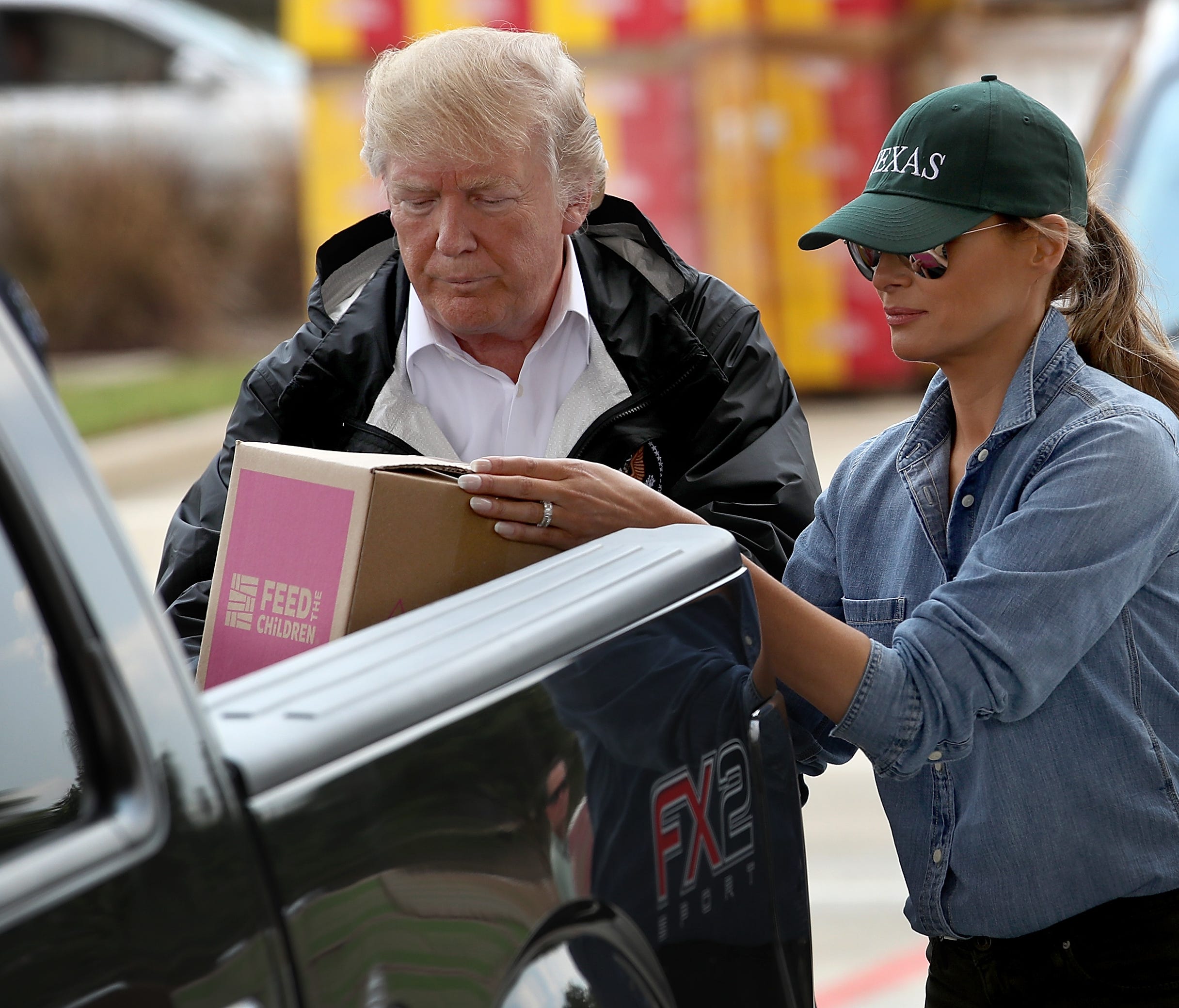 President Trump and first lady Melania Trump load emergency supplies into the back of a pickup truck for  residents impacted by Hurricane Harvey while visiting the First Church of Pearland September 2, 2017 in Pearland, Texas.