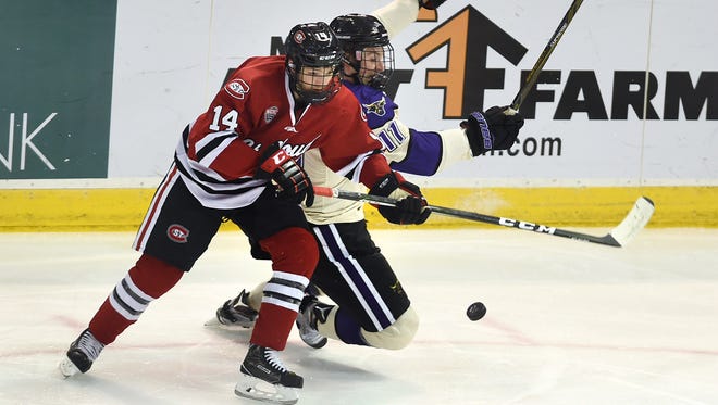 St. Cloud State right wing Patrick Wahlin protects the puck from Minnesota State-Mankato defender Sean Flanagan during the first period Saturday night at Verizon Wireless Center in Mankato.