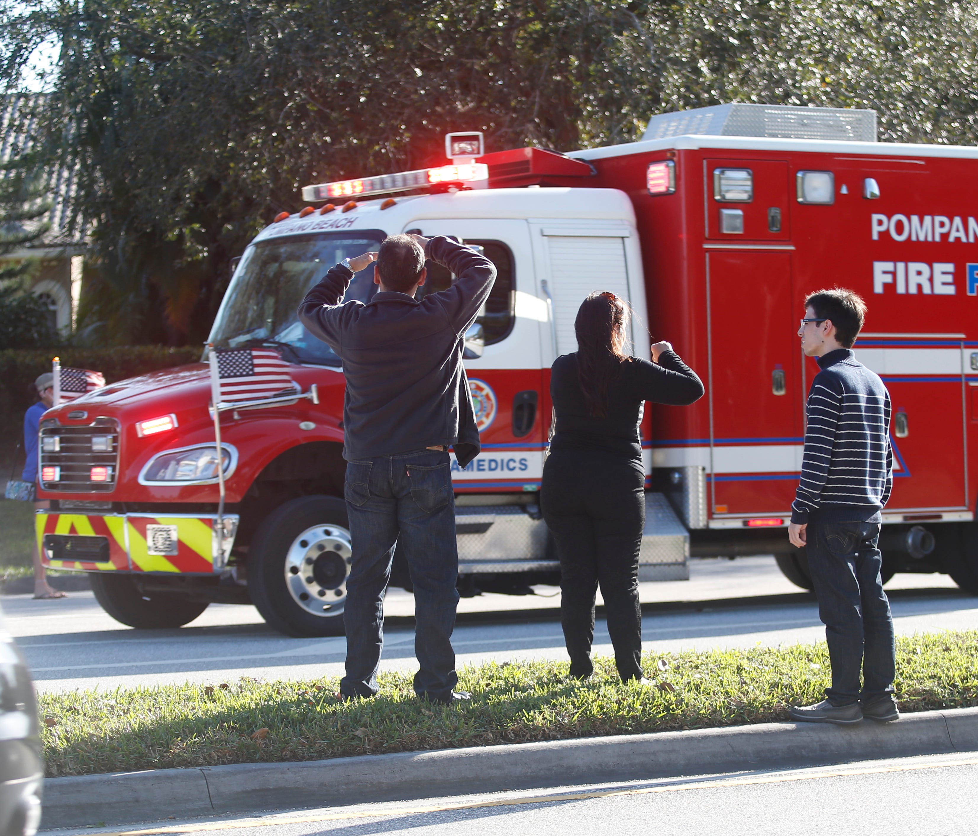 Anxious family members watch a rescue vehicle pass by in Parkland, Fla.