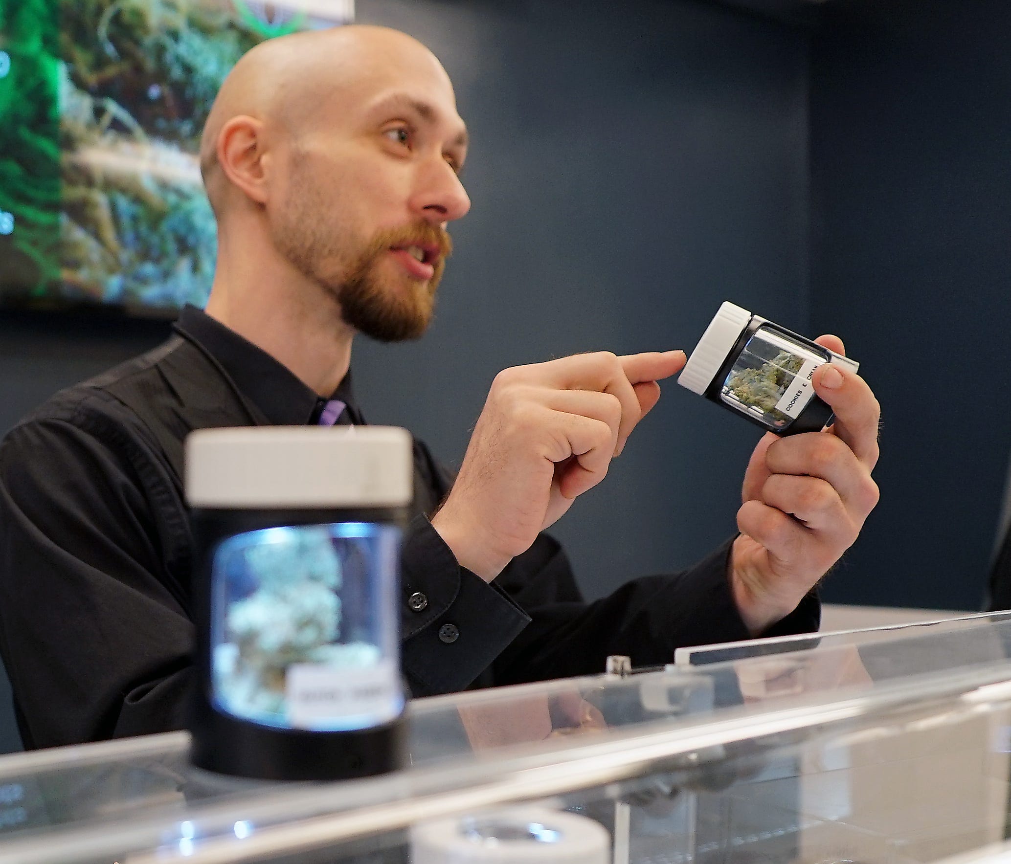 A clerk at the Cannabaska marijuana store in Anchorage discusses the particulars of a strain of cannabis with a customer. The store's owner recruited workers from Colorado, which has a more established marijuana industry.      