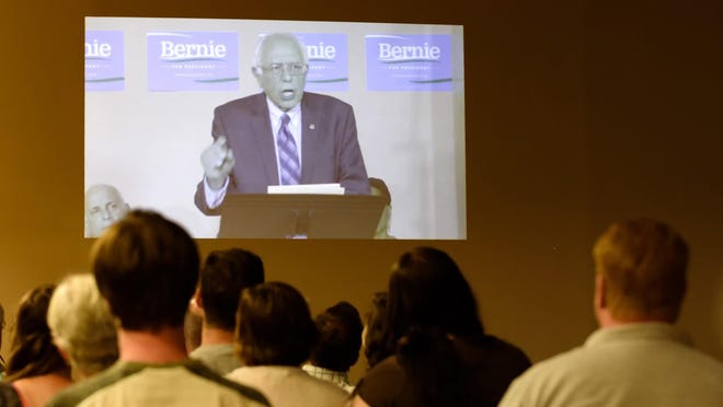 Delaware supporters of Bernie Sanders gather Wednesday at the George Wilson Community Center in Newark to listen to Democratic presidential candidate Bernie Sanders speak via video conference from Washington, D.C.