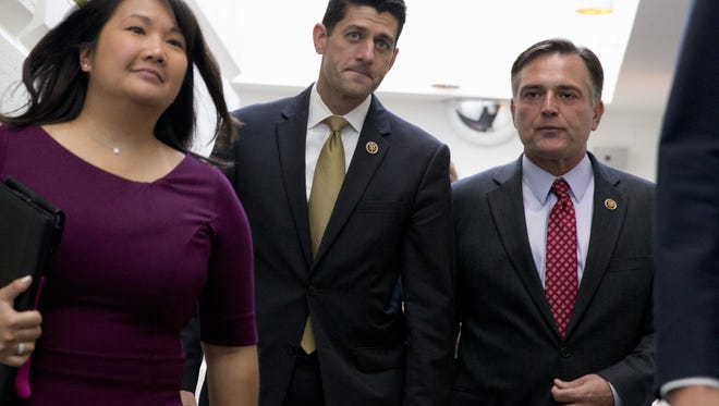 Rep. Paul Ryan, center, leaves a caucus meeting with Rep. Luke Messer earlier this year.