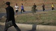 Boys jog at the end of a work day in Pyongyang on April