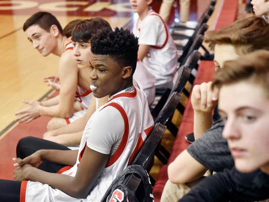 Jarace Walker, center, waits for a ninth-grade basketball