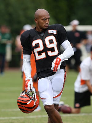 Cornerback Leon Hall stretches during Cincinnati Bengals training camp on the practice field at Paul Brown Stadium in 2014.