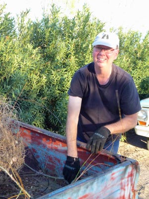 Rob Sharp trims plants in his yard; generally every weekend he performs yard work, and is pleased that the free green waste recycling program is starting up again May 1st at the seven of the nine County Collection Centers throughout Doña Ana County.