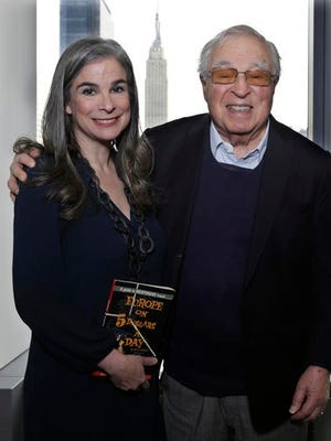 In this Jan. 6, 2017 photo, Arthur Former, 87, right, poses with his daughter, Pauline, in New York. It's been 60 years since the publication of Frommer's legendary travel guidebook, "Europe on $5 a Day." Frommer's message of authentic, bargain travel was revolutionary in its day, encouraging average people and not just the wealthy to travel. Today there are 101 Frommer's guidebooks to destinations around the world and a Frommers.com website.