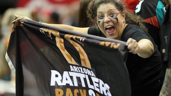 An Arizona Rattlers fan celebrates her team's win against the Cleveland Gladiators Saturday, Aug. 23, 2014.