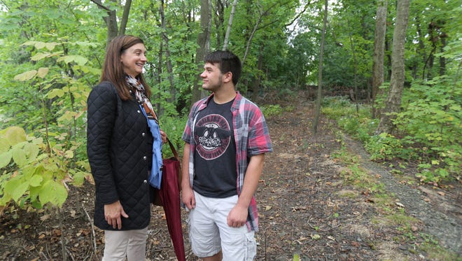 Susan Mutti, deputy mayor for the village of Pelham, and Mike Ruggiero, 16, a Boy Scout with New Rochelle Troop 11, on a trail above the Highbrook Avenue Bridge in Pelham. Ruggiero wants to lead a team clearing and sprucing up a path as part of his Eagle Scout project.