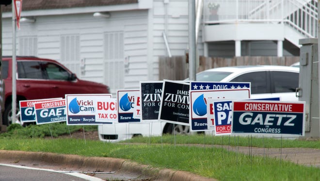Political campaign signs dot the landscape in high traffic areas, like the corner of Bayfront Pkwy, and East Chase Street.