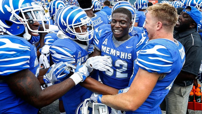 Memphis defensive back Jacobi Francis (second right) celebrates with his teammates after knocking down UCLA's fourth-down pass to end the game Saturday, Sept. 16, 2017, giving the Tigers a 48-45 win at Liberty Bowl Memorial Stadium.