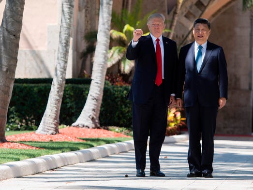 Trump pumps his fist as he and Chinese President Xi