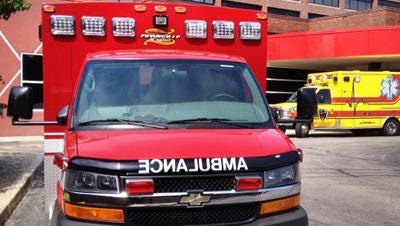 An ambulance sits outside an emergency room.
