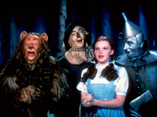 In this 1939 file photo originally released by Warner Bros., from left, Bert Lahr as the Cowardly Lion, Ray Bolger as the Scarecrow, Judy Garland as Dorothy, and Jack Haley as the Tin Woodman, are shown in a scene from "The Wizard of Oz."