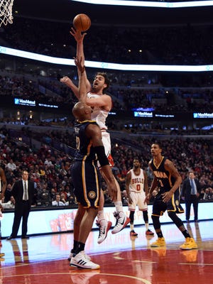 Mar 18, 2015; Chicago, IL, USA;  Chicago Bulls forward Pau Gasol (16) shoots over Indiana Pacers forward David West (21) during the first half at the United Center. Mandatory Credit: David Banks-USA TODAY Sports