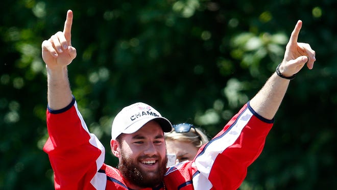 Washington Capitals right wing Tom Wilson waves to the crowd during the Stanley Cup championship parade.