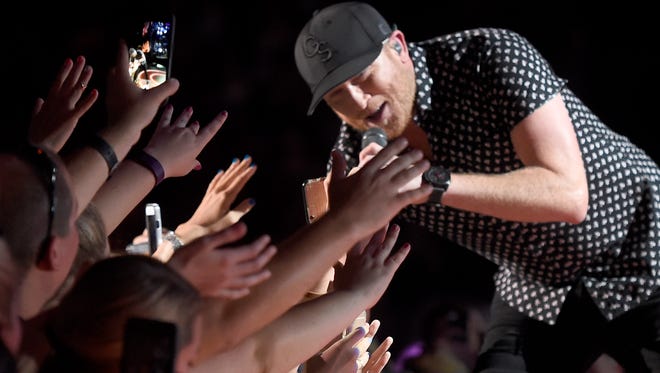 Cole Swindell gets close with his fans at the 2016 CMA Music Festival on Saturday night at Nissan Stadium in Nashville.
