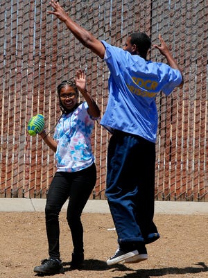 Taniya Ellis, 12, plays football with her father and other men incarcerated at Salinas Valley State Prison during Camp Grace.