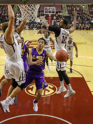 LSU Tigers guard Tremont Waters (3) goes up for a shot over Texas A&M Aggies forward DJ Hogg (1) and center Tonny Trocha-Morelos (10) at Reed Arena.