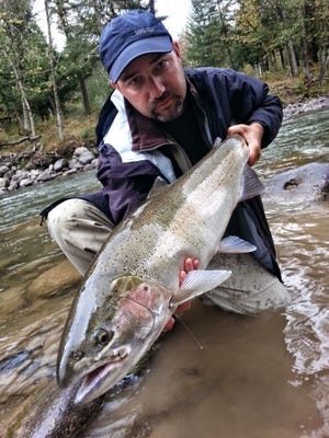 Randy Bales shows off a steelhead. Winter steelhead is starting slow, but numbers should increase into March.