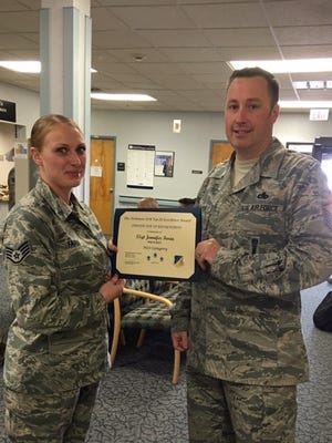 Staff Sgt. Jennifer Faria, 49th Aerospace Medical Squadron public health technician, is presented the Top III non-commissioned officer award for April from Master Sgt. Timothy Gatten, 54th Aircraft Maintenance Squadron first sergeant and Top III President, at Holloman Air Force Base on May 24, 2017. During the month of April, Faria inspected 25 food and public facilities, identified 20 discrepancies that required attention, essentially protecting approximately 18 thousand people from foodborne illness outbreaks. Faria is dedicated to mentoring Airmen, and briefed the First Term Airman Center on topics including The Enlisted Force Structure and on the Airman Comprehensive Assessment.