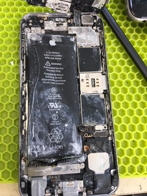 The inside of an iPhone that had gotten wet and then corroded.