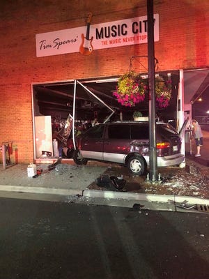 A van slammed into Tim Spear's Music City late Sunday night after another vehicle attempted a lefthand turn onto Main Street off Arch Avenue.