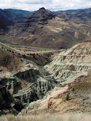 The Blue Basin Overlook Trail in John Day Fossil Beds National Monument features gorgeous views of volcanic ash that has turned to blue-green claystone, now exposed to the weather and carved into towering cliffs. The three-mile trail loops around the rock formation and up the hillsides of the surrounding John Day River Valley.