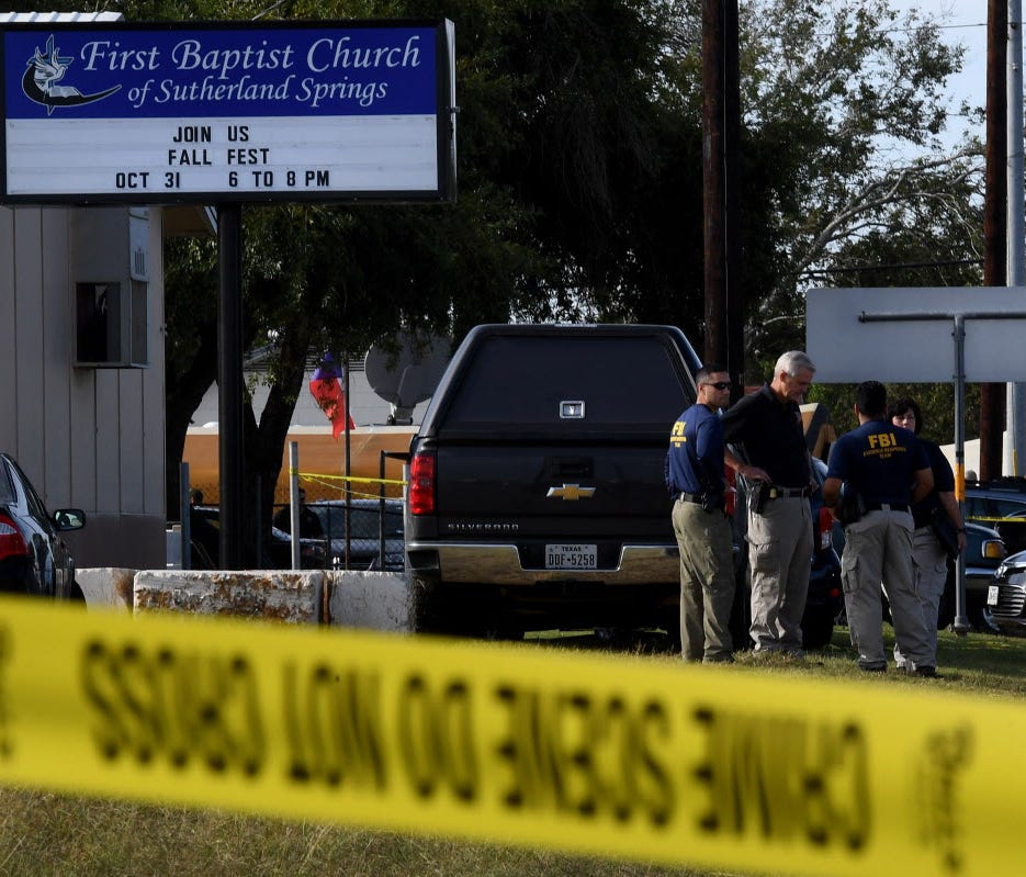 FBI agents search for clues at the entrance to the First Baptist Church, after a mass shooting that killed 26 people in Sutherland Springs, Texas on Nov. 6, 2017.