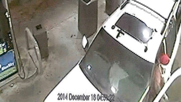 Surveillance shows a man wearing a Santa hat exiting an SUV.