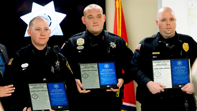 From left, Loudon County Sheriff deputies Brandon Dishner, Brandon Pesterfield and Lenoir City Police Lt. Jeremy Dishner pose with their Life Saving Awards during an ceremony at the Loudon County Sheriff's Office in Knoxville, Tennessee on Thursday, February 15, 2018. Two Loudon County Sheriff's deputies and a Lenoir City Police officer were honored for their heroic efforts in saving residents of an apartment duplex last week.
