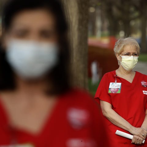 Nurses stand in protest in front of Research Medic