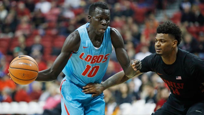 New Mexico's Makuach Maluach, shown driving on  UNLV's Tervell Beck, and his teammates have won three of their past four games to move up to No. 4 in our Mountain West power rankings.