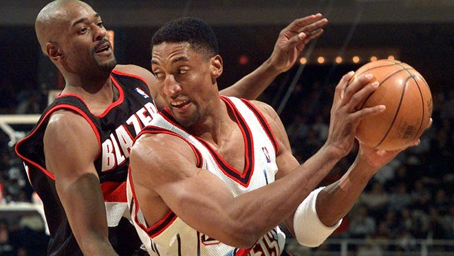 Houston Rockets' Scottie Pippen (33) looks to pass the ball as Portland Trail Blazers' Stacey Augmon defends during the third quarter in this April 15, 1999 photo, in Houston. Scottie Pippen's brief stint with the Houston Rockets is over, just eight months after it began. In a six-for-one deal, Pippen will be traded Saturday, Oct. 2, to the Portland Trail Blazers, The Associated Press learned Friday, Oct. 1, 1999.