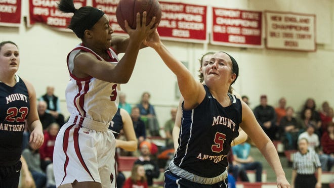 CVU's Mekkena Boyd (3) and Mount Anthony's Breanna Harris (5) battle for the rebound during the girls basketball game between the Mount Anthony Patriots and the Champlain Valley Union Redhawks on Saturday afternoon.