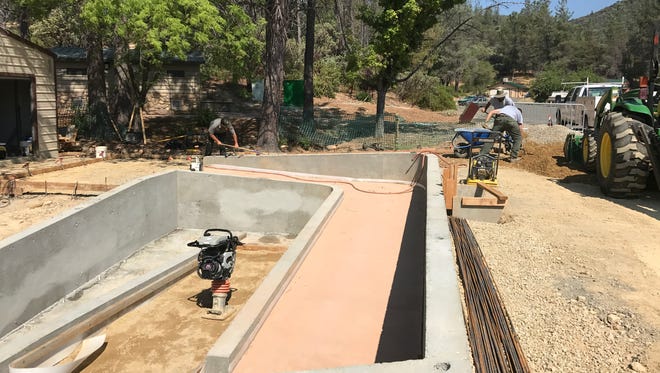 Crews build a wheelchair accessible kayak launch this week at Whiskeytown Lake. Money for the program came from entrance fees into the national recreation area, which are slated to increase next year.